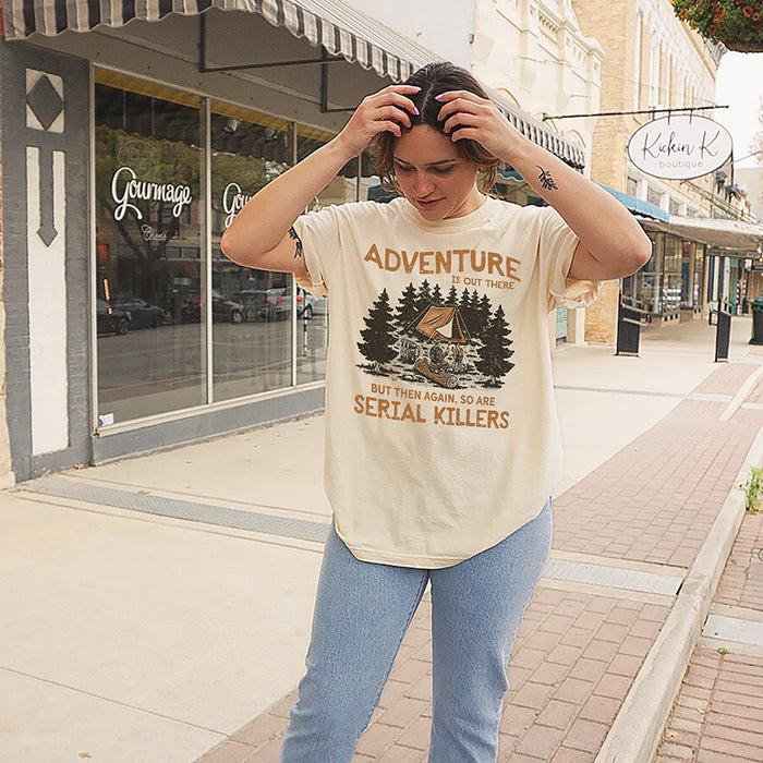 Model wearing Adventure Is Out There tee in ivory — funny camping graphic t-shirt for women