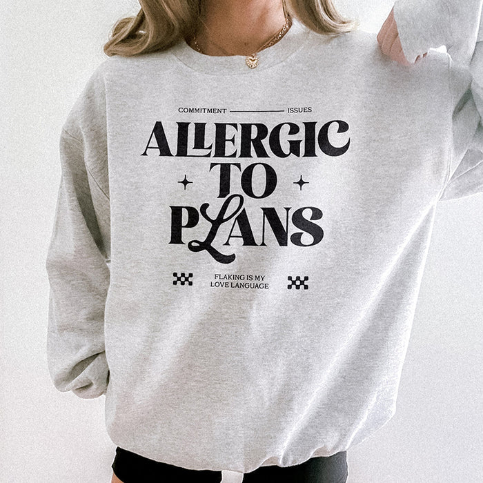 Woman wearing the Allergic to Plans ash grey sweatshirt with black leggings — casual, relaxed outfit for homebodies.