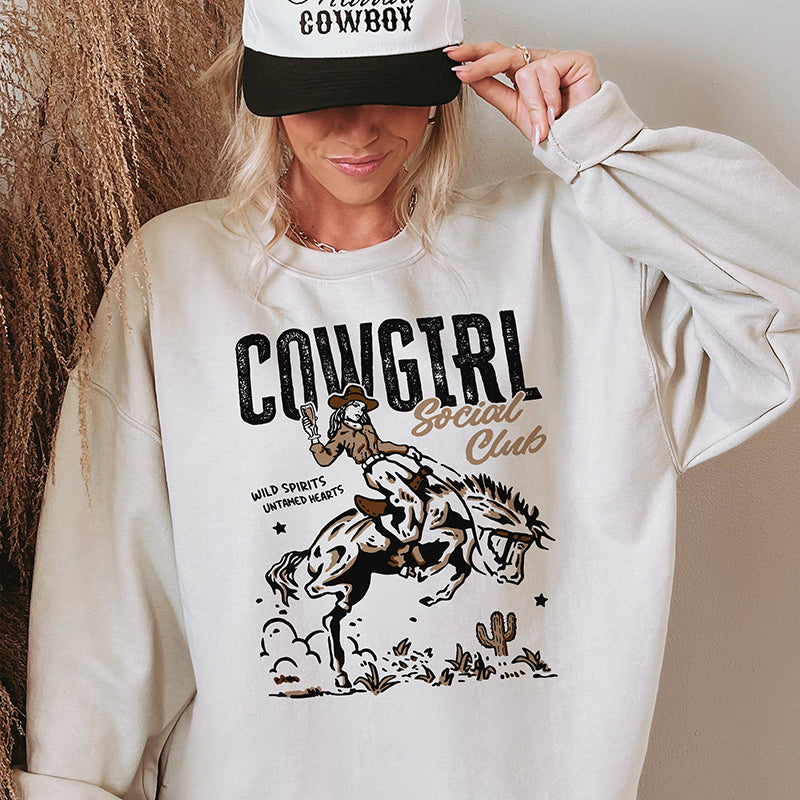 Close-up model photo of sand sweatshirt — cozy country crewneck with retro cowgirl vibes
