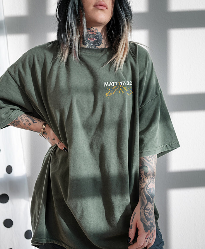 Model wearing moss Faith Can Move Mountains tee — relaxed unisex fit faith-based shirt