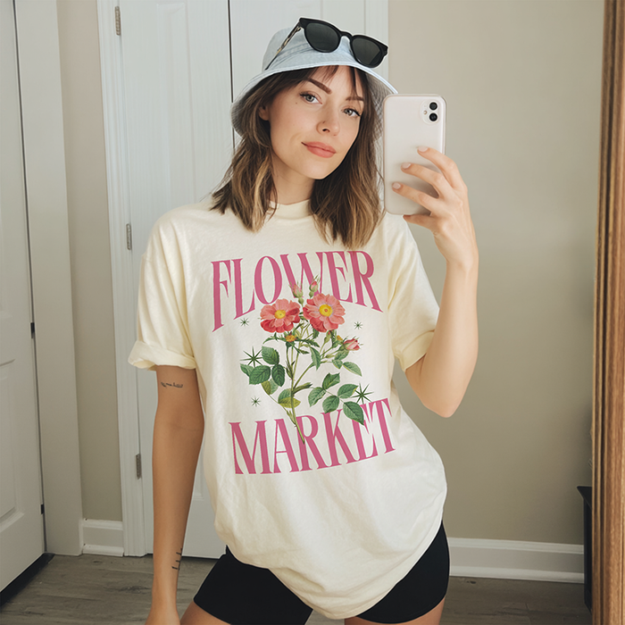 Model in ivory Flower Market tee — soft garment-dyed floral graphic shirt for spring and summer