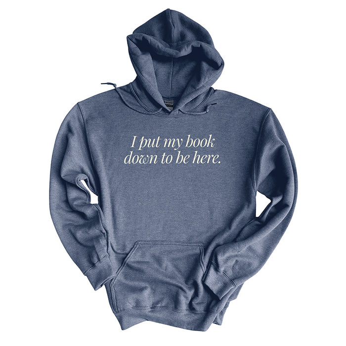 Flat lay of heather dark navy “I Put My Book Down To Be Here” hoodie – cozy unisex book lover pullover