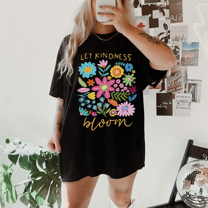 Model wearing Let Kindness Bloom tee in black — floral spring graphic t-shirt for women