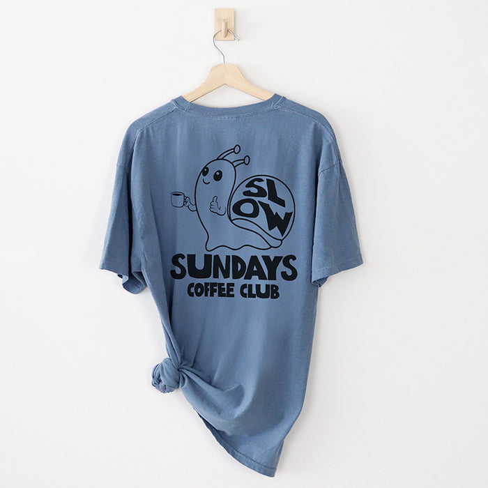 Flat lay of back design on blue jean tee — espresso lovers graphic tee