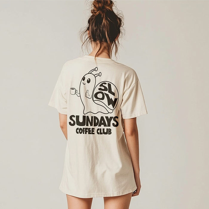 Model wearing ivory Slow Sundays Coffee Club tee — back print with snail and coffee club design