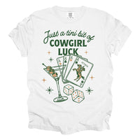 Flat lay of Just a Tini Bit of Cowgirl Luck tee in white — multicolor western shirt with playful design