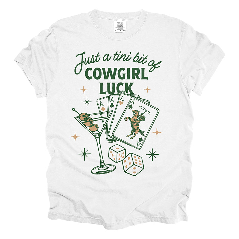 Flat lay of Just a Tini Bit of Cowgirl Luck tee in white — multicolor western shirt with playful design