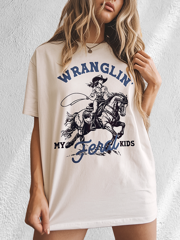 Model indoors in ivory feral kids tee — motherhood humor shirt for women